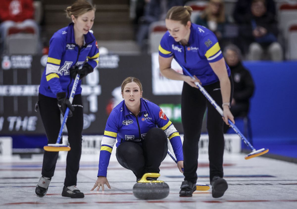Team Alberta skip Selena Sturmay watches her shot while lead Paige Papley, right, and second Dezaray Hawes look on as they play Team Manitoba-Cameron in Page playoffs at the Scotties Tournament of Hearts in Calgary, Saturday, Feb. 24, 2024.