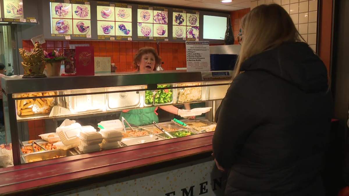 Amy Quon serving customers at the Chicken for Lunch eatery in the food court at Rice Howard Place in downtown Edmonton on Wednesday, February 28, 2024.