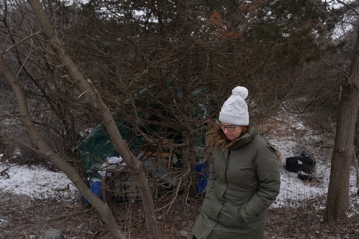 Debbie Lee Pike, founder of "Not Alone Team – Quinte" a volunteer group that distributes food, clothes and supplies to homeless people, visits a tented home in Belleville, Ont., on Thursday, Feb. 15, 2024. The city recently declared a state of emergency after responding to 17 overdoses in just 24 hours. 