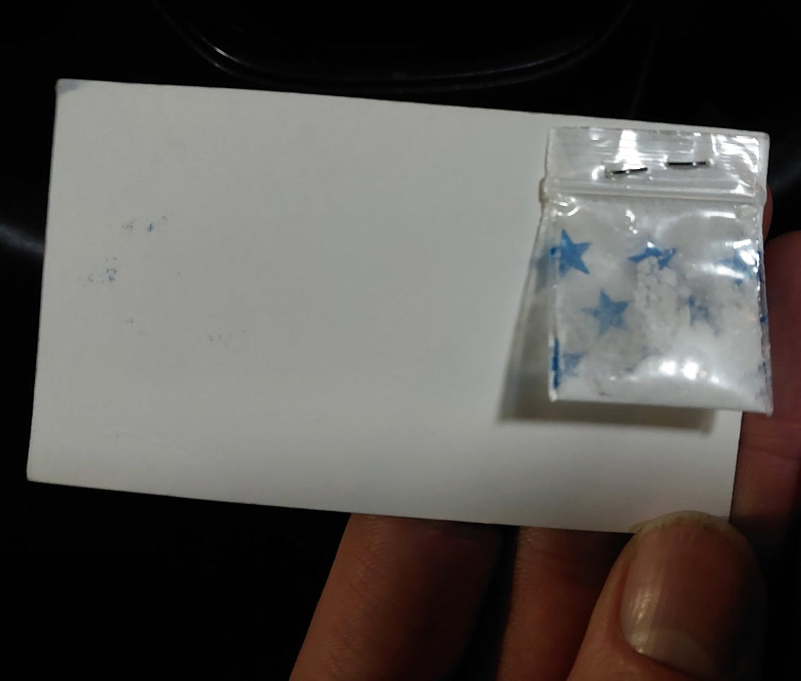 Police have laid drug-trafficking charges after a man allegedly handed out business cards with free samples of cocaine in Calgary.