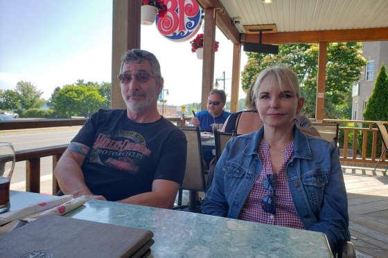 Mike, 66, and Elaine Foley, 67 sitting at a resturant.