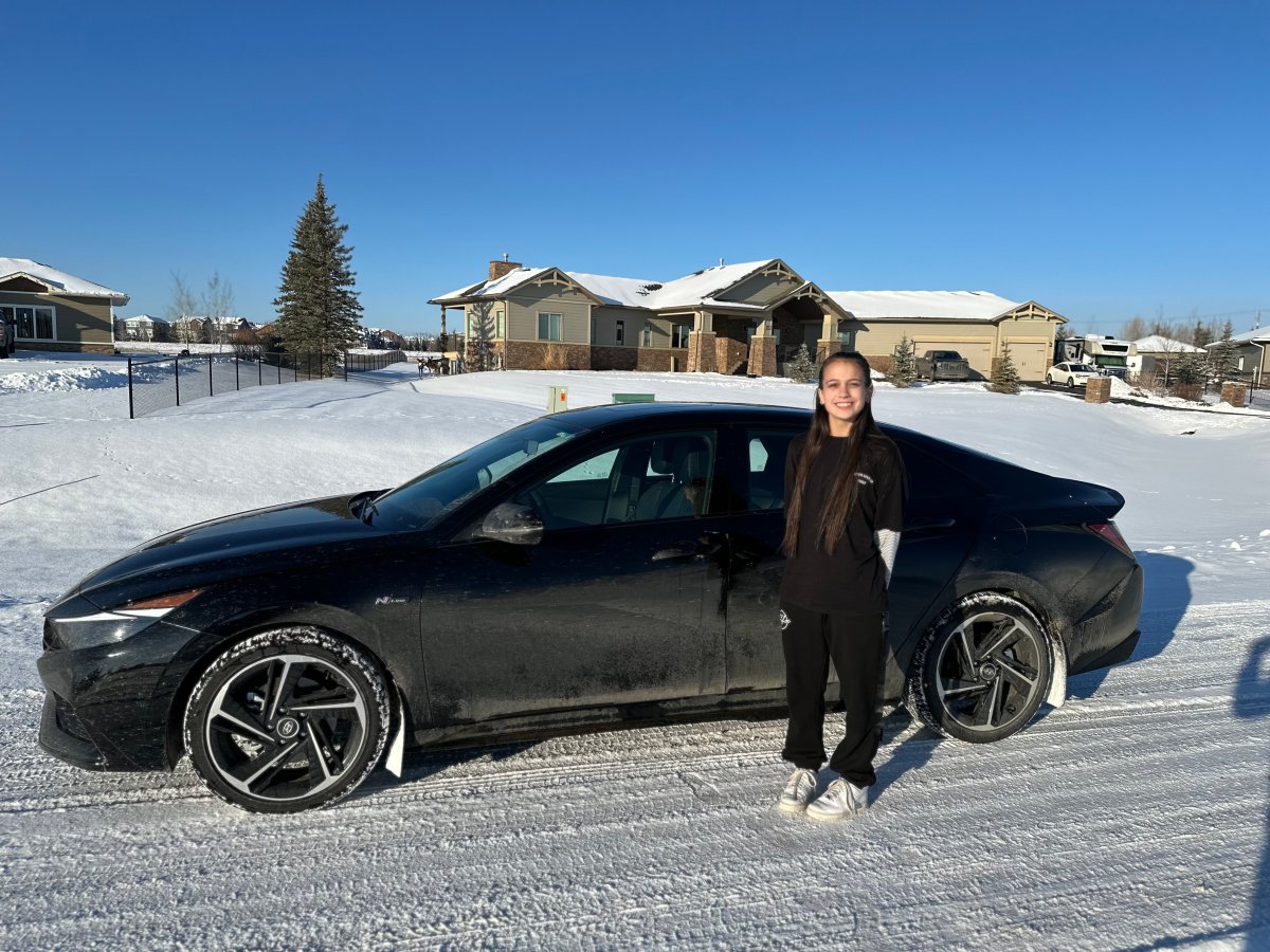Kailee Gray in front of new vehicle