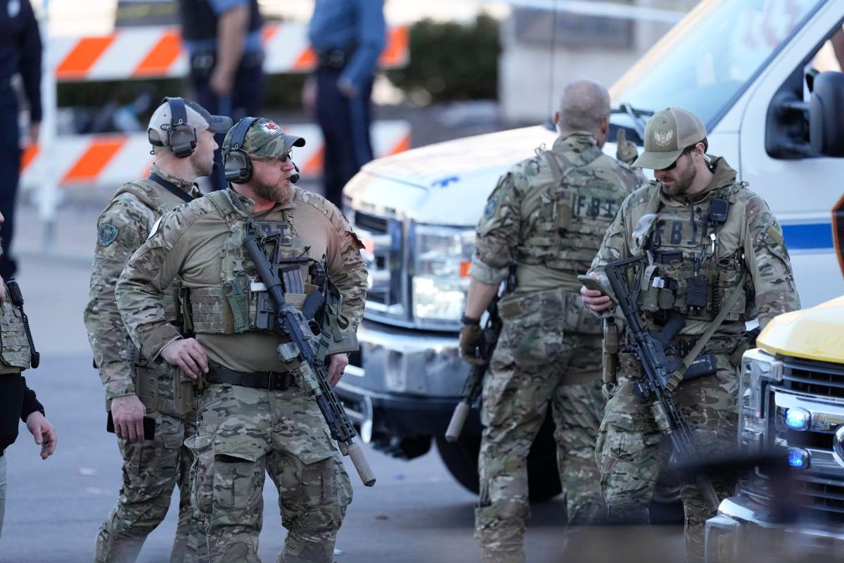 Law enforcement officers look around the scene after an incident following the Kansas City Chiefs victory parade in Kansas City, Mo., Wednesday, Feb. 14, 2024. The Chiefs defeated the San Francisco 49ers Sunday in the NFL Super Bowl 58 football game.