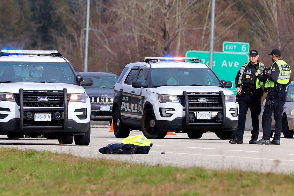 Police attend the scene of a hit-and-run collision on Highway 91 in Delta, B.C. on Sat. Feb. 17, 2024.