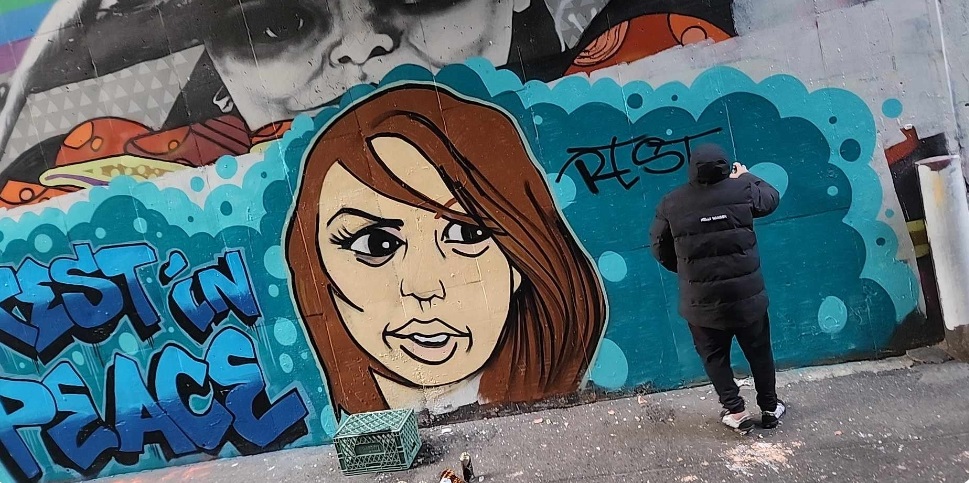 Vancouver street artist Smokey D paints a mural honouring Celena Loschiavo.