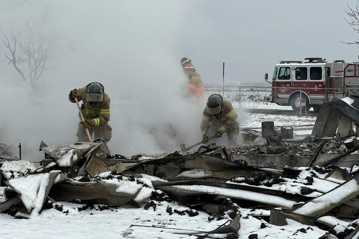 Firefighters work through rubble of burned homes from the Smokehouse Creek fire in Stinnett, Texas on Thursday, Feb. 29, 2024. A wildfire spreading across the Texas Panhandle became the largest in state history Thursday, as a dusting of snow covered scorched prairie, dead cattle and burned out homes and gave firefighters a brief window of relief in desperate efforts to corral the blaze. (AP Photo/Ty O’Neil)