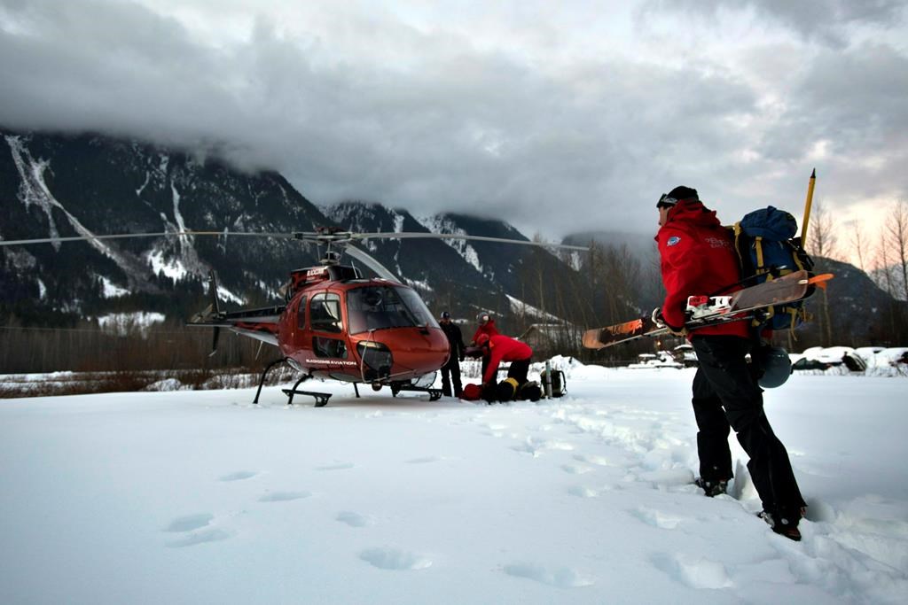 Six skiers have been rescued in two separate operations in the mountains in southwestern British Columbia. Rescue crew members board a helicopter in Pemberton, B.C., in a Monday, Jan. 12, 2015, file photo. THE CANADIAN PRESS/Dave Steers.