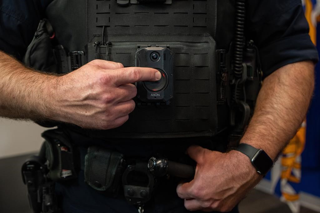 An overhaul of Ontario's 34-year-old law governing policing in the province is set to take effect next month, with its rules and regulations covering everything from oversight to discipline to how officers are equipped. A police officer demonstrates recording on a body camera during a news conference, in Surrey, B.C., on Thursday, Jan. 11, 2024. THE CANADIAN PRESS/Ethan Cairns.