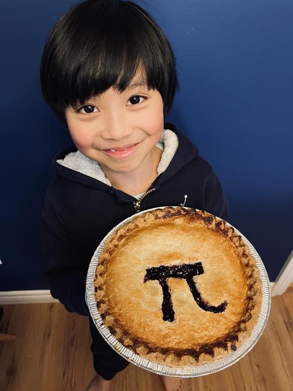 Lucas Mason Yao from Pitt Meadows, B.C., holds a pie with a Pi sign on it in a 2023 handout photo. Yao has memorized the ratio between a circle's circumference and its diameter to 2,030 digits, far beyond the three-point-one-four that's close enough for most people. THE CANADIAN PRESS/HO-Cindy Liu.