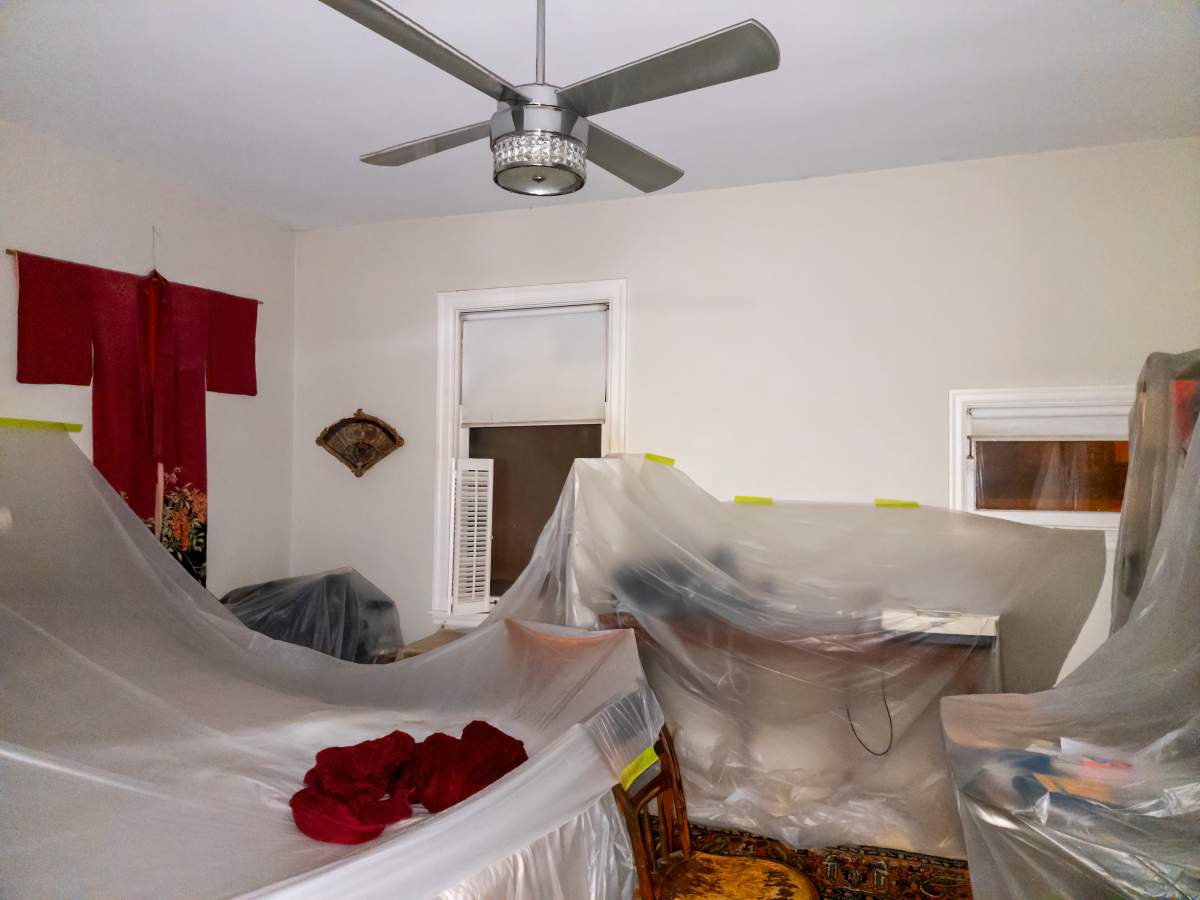 Clear plastic sheets cover most of Stuart's furniture to prevent damage from potential leaks.