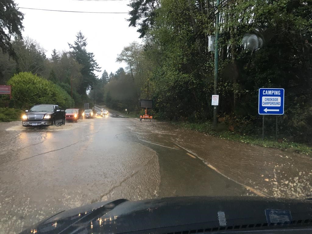 Cars move through floodwater along the Sunshine Coast Highway near Sechelt, B.C., during the atmospheric river event in a November 2021 handout photo.