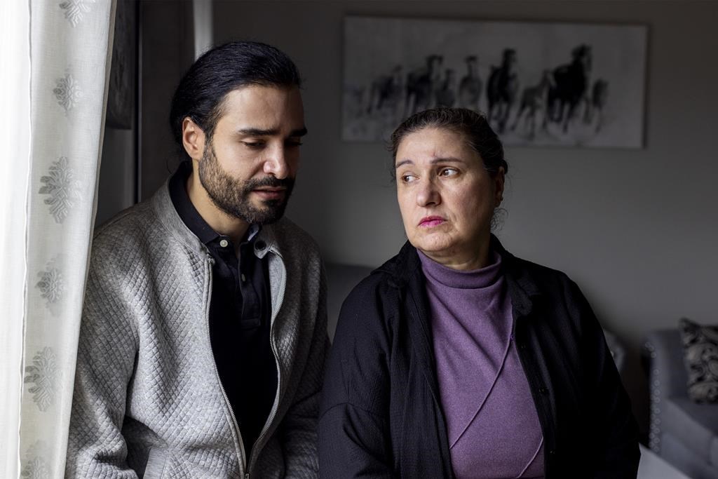 Palestinian Canadians, Marcus Karashuli, 36, and his mother, Sawsan Karashuli, 62, have applied through the federal government visa program to get two family members out of Gaza. They say one of those family members has now starved to death while waiting to hear something from the government in Kitchener, Ont., on Friday, March 15, 2024. THE CANADIAN PRESS/Carlos Osorio.