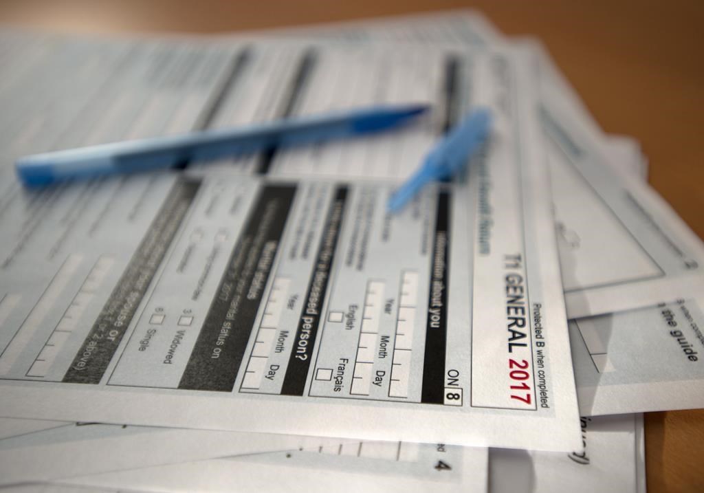 Tax forms are shown in Toronto on Thursday April 5, 2018. A Brampton, Ont., man has been given a three-year prison sentence for his role in a fraud case involving more than $34 million in false charitable donations. 
