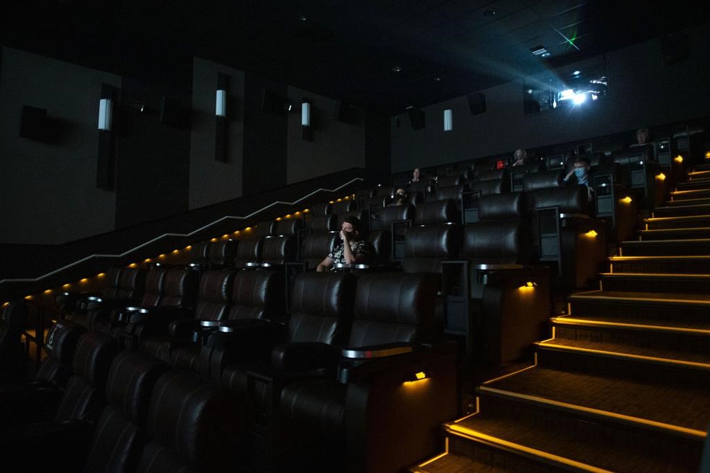 A movie buff expecting to see a South Indian action epic at a theatre in British Columbia was let down after a spate of shootings thousands of kilometres away disrupted his plans. Moviegoers sit in a theatre at a Cineplex in Toronto, Tuesday, Oct. 6, 2020. 