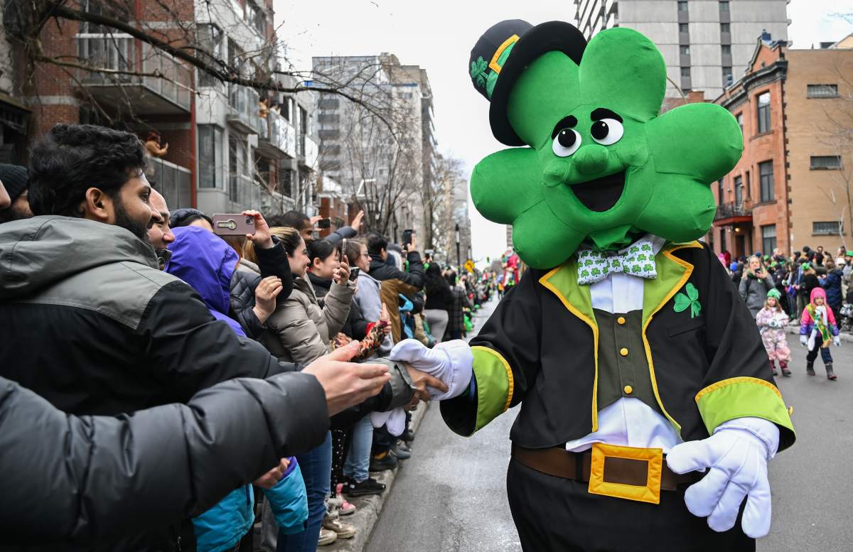 A participant dressed as a shamrock greets members of the crowd during the St. PatrickÕs Day parade in Montreal, Sunday, March 17, 2024. THE CANADIAN PRESS/Graham Hughes