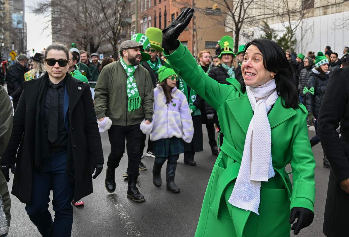 Montreal Mayor Valerie Plante, right, waves to the crowd during the St. PatrickÕs Day parade in Montreal, Sunday, March 17, 2024. THE CANADIAN PRESS/Graham Hughes