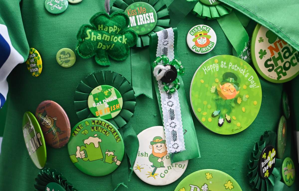A person wears a collection of badges and pins on their jersey during the St. PatrickÕs Day parade in Montreal, Sunday, March 17, 2024. THE CANADIAN PRESS/Graham Hughes