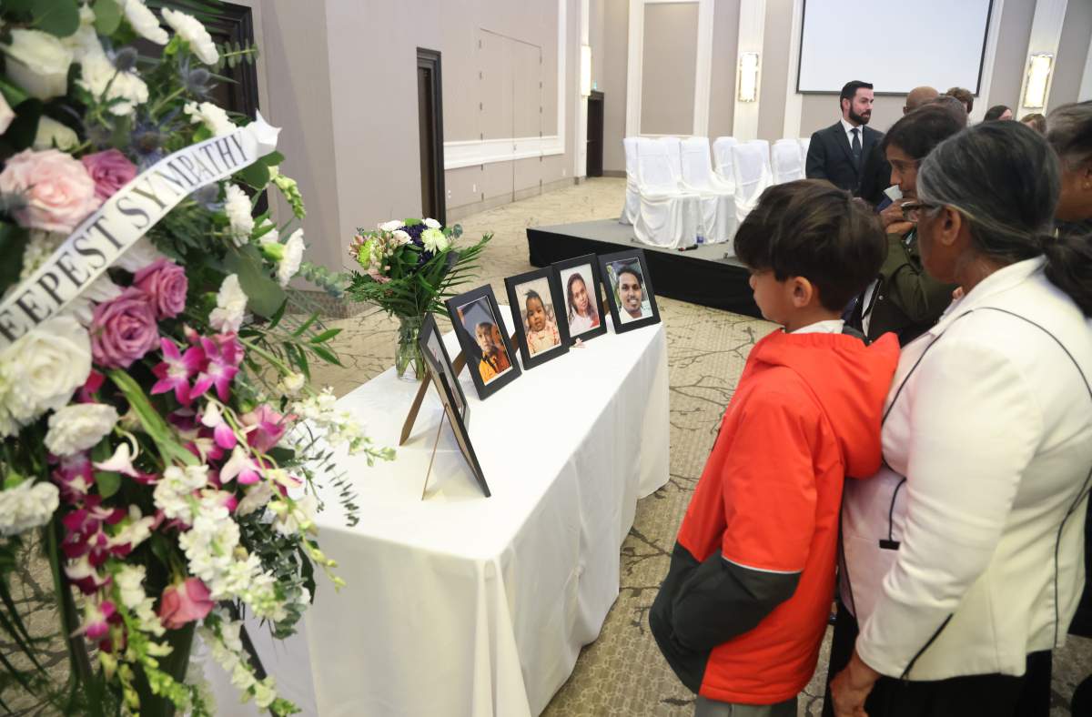 People pay their respects at the funeral service for the victims of a mass stabbing that killed a mother, her four young children and a family friend, in Ottawa on Sunday, March 17, 2024.