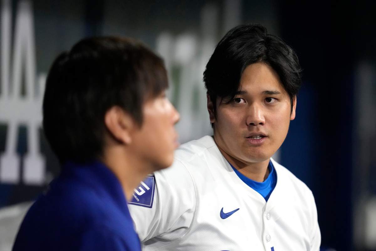 Los Angeles Dodgers' designated hitter Shohei Ohtani, right, chats with his interpreter Ippei Mizuhara during an exhibition baseball game between Team Korea and the Los Angeles Dodgers at the Gocheok Sky Dome in Seoul, South Korea, Monday, March 18, 2024. Ohtani’s interpreter and close friend has been fired by the Dodgers following allegations of illegal gambling and theft from the Japanese baseball star.
