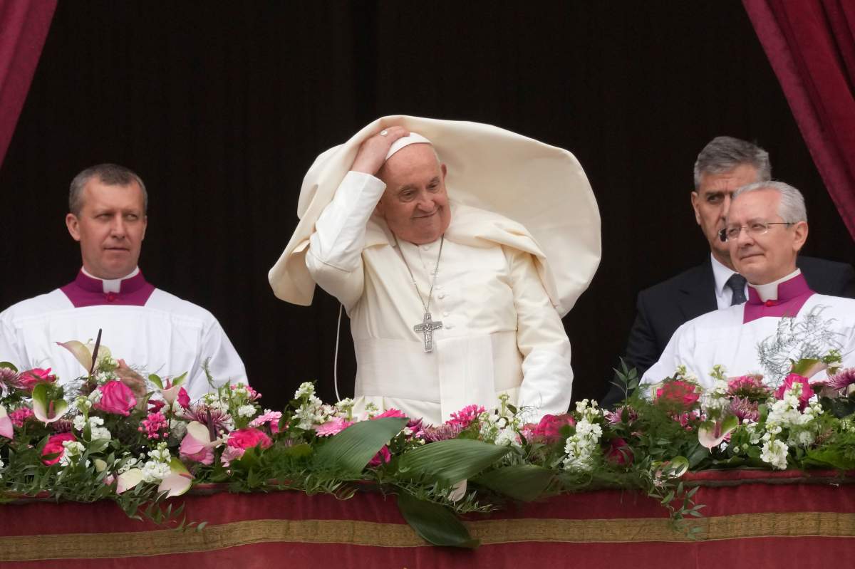 Pope Francis smiles from the central balcony of the St. Peter’s Basilica prior to the ‘Urbi et Orbi’ (To the city and to the world) blessing, at the Vatican, Sunday, March 31, 2024.