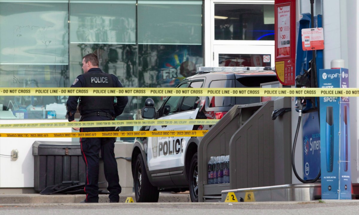 Evidence markers can be seen on the ground at a gas station on Appleby Line in Burlington, Ont. where the SIU, Halton Regional Police and OPP are investigating a police involved shooting at the Esso station on Saturday, September 22, 2018. Halton Regional Police have confirmed that two of their officers were injured during the incident and are receiving treatment for their injuries. There are reports that the suspect is deceased at the scene. The SIU have been called in to investigate. THE CANADIAN PRESS/Peter Power.