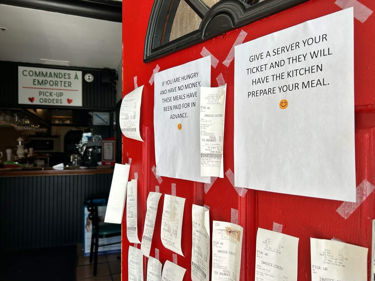 The door of Emma’s Pizzeria is plastered with receipts of donated meals.
