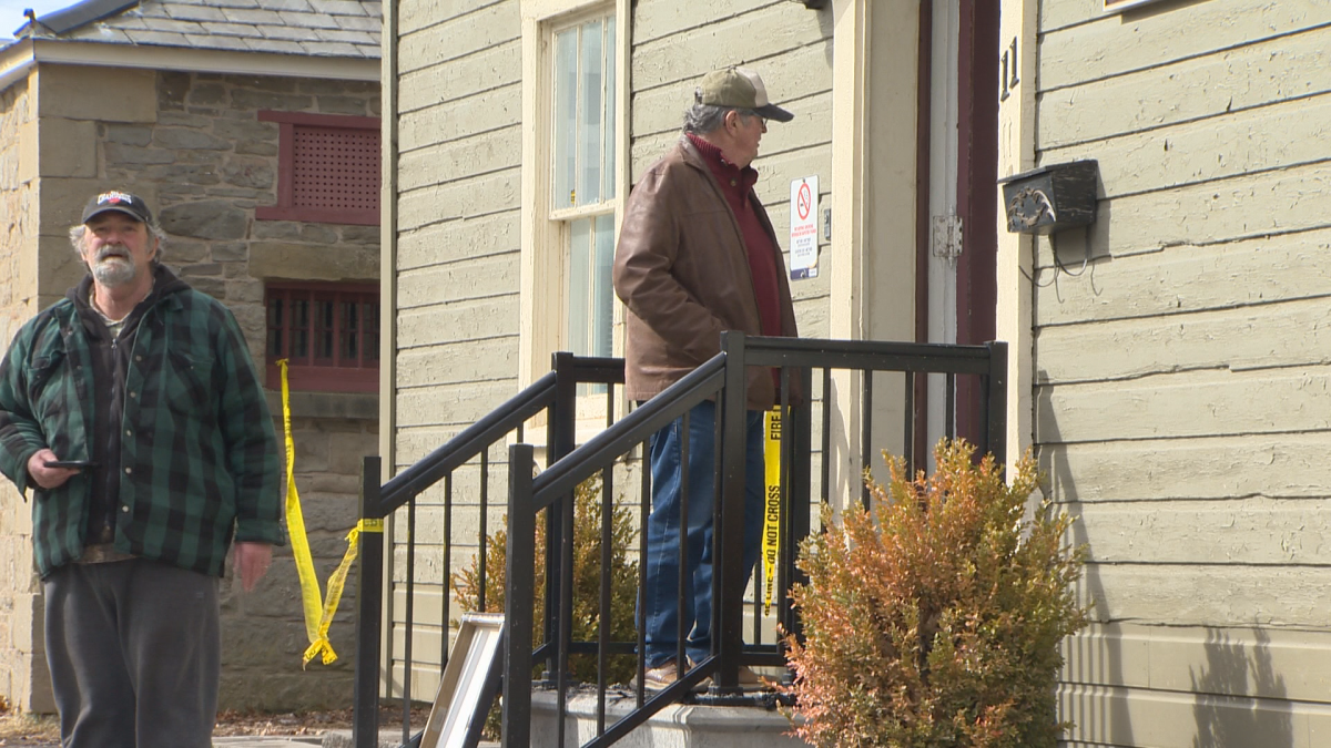 Bob and Kenny McGinn survey the damage to their former childhood home.