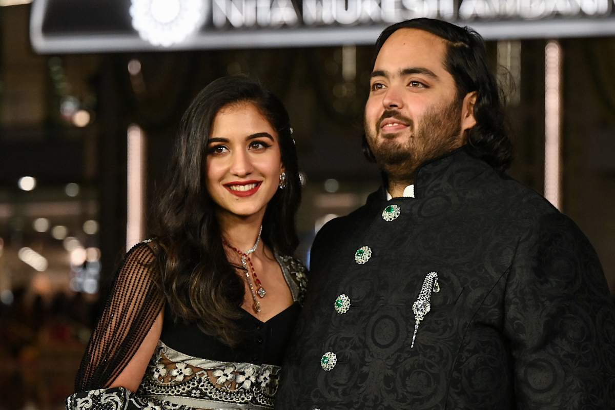 Anant Ambani and Radhika Merchant. They are smiling and wearing black.