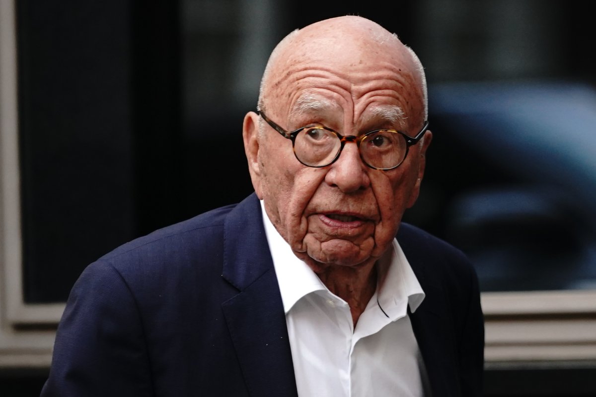 Rupert Murdoch. He is wearing glasses and a blue suit jacket.