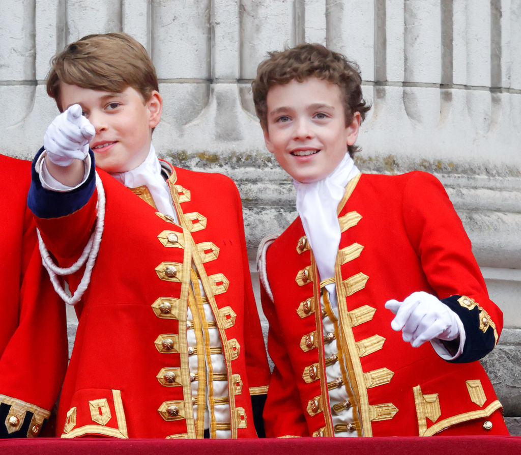 Prince George of Wales (in his role as Page of Honour) and Page of Honour Lord Oliver Cholmondeley watch an RAF flypast from the balcony of Buckingham Palace following the Coronation of King Charles III & Queen Camilla at Westminster Abbey on May 6, 2023 in London, England.