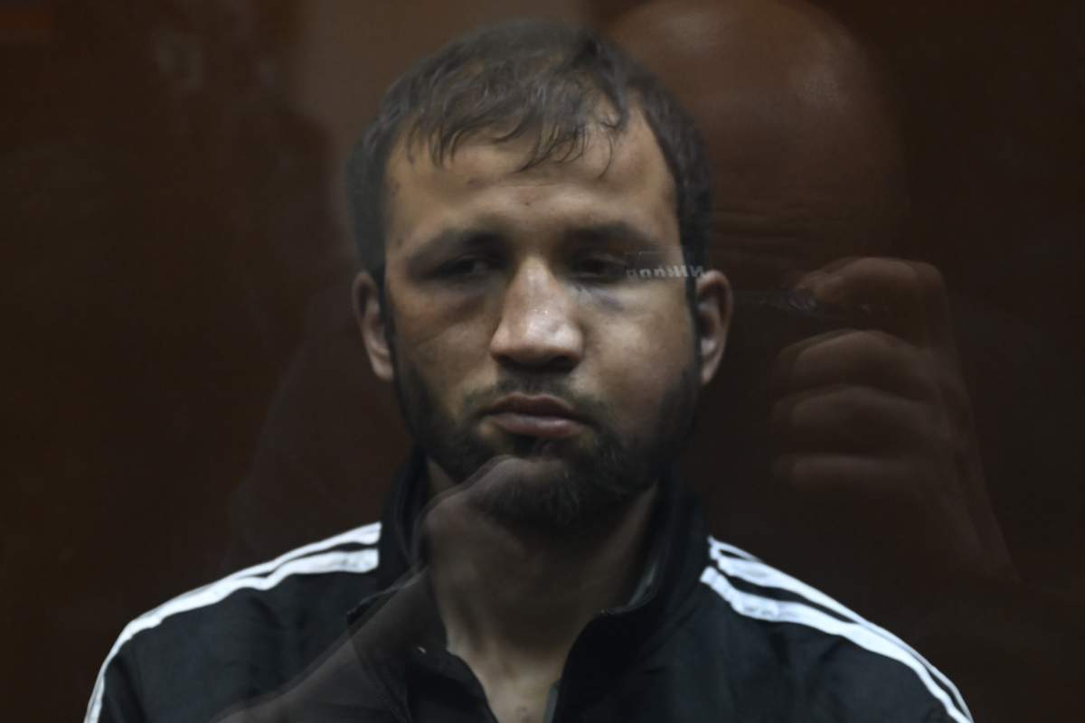 Shamsidin Fariduni, one of four suspects accused of opening fire in a music hall in Moscow, is seen in court with visible injuries to his face.