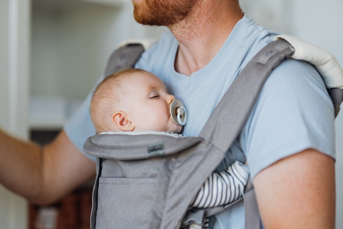 Dad holding his baby in a carrier