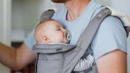 Dad holding his baby in a carrier