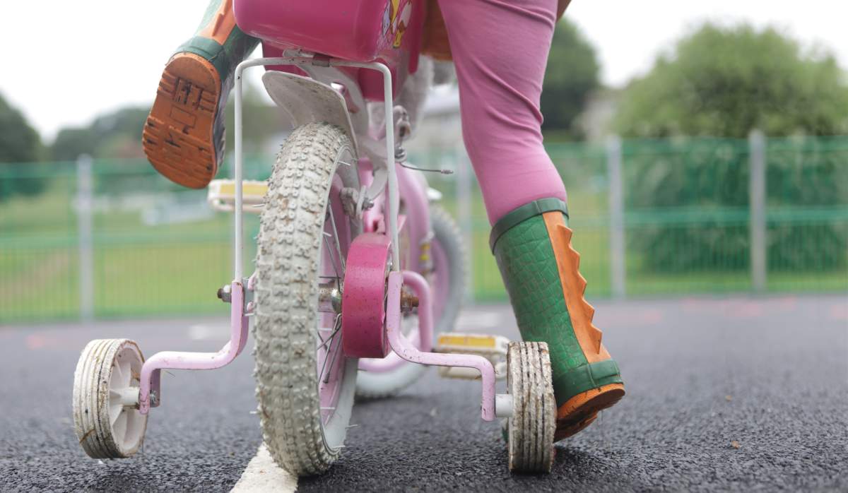Toddler on a bike with training wheels