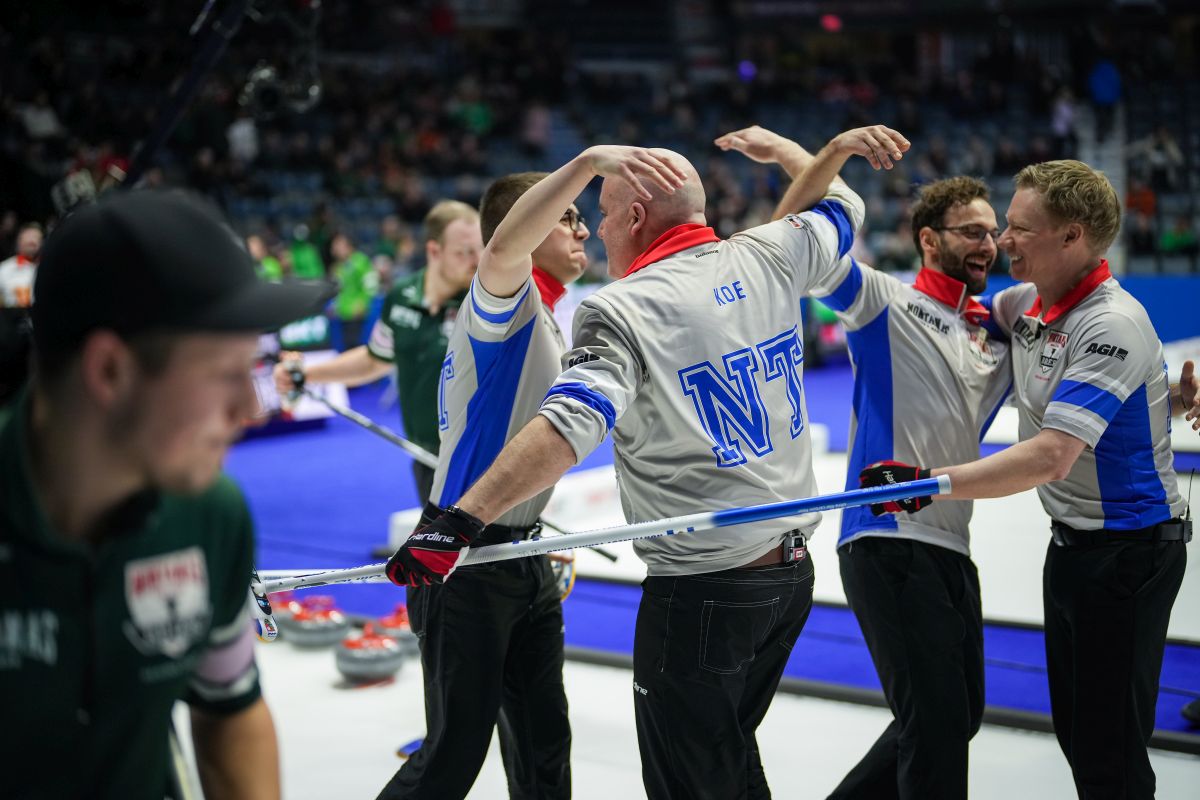 Northwest Territories second Cole Parsons, back from left to right, skip Jamie Koe, lead Shadrach McLeod and third Glen Kennedy celebrate after defeating Prince Edward Island 9-8 in 11 ends to qualify for the playoffs at the Brier, in Regina, on Thursday, March 7, 2024.