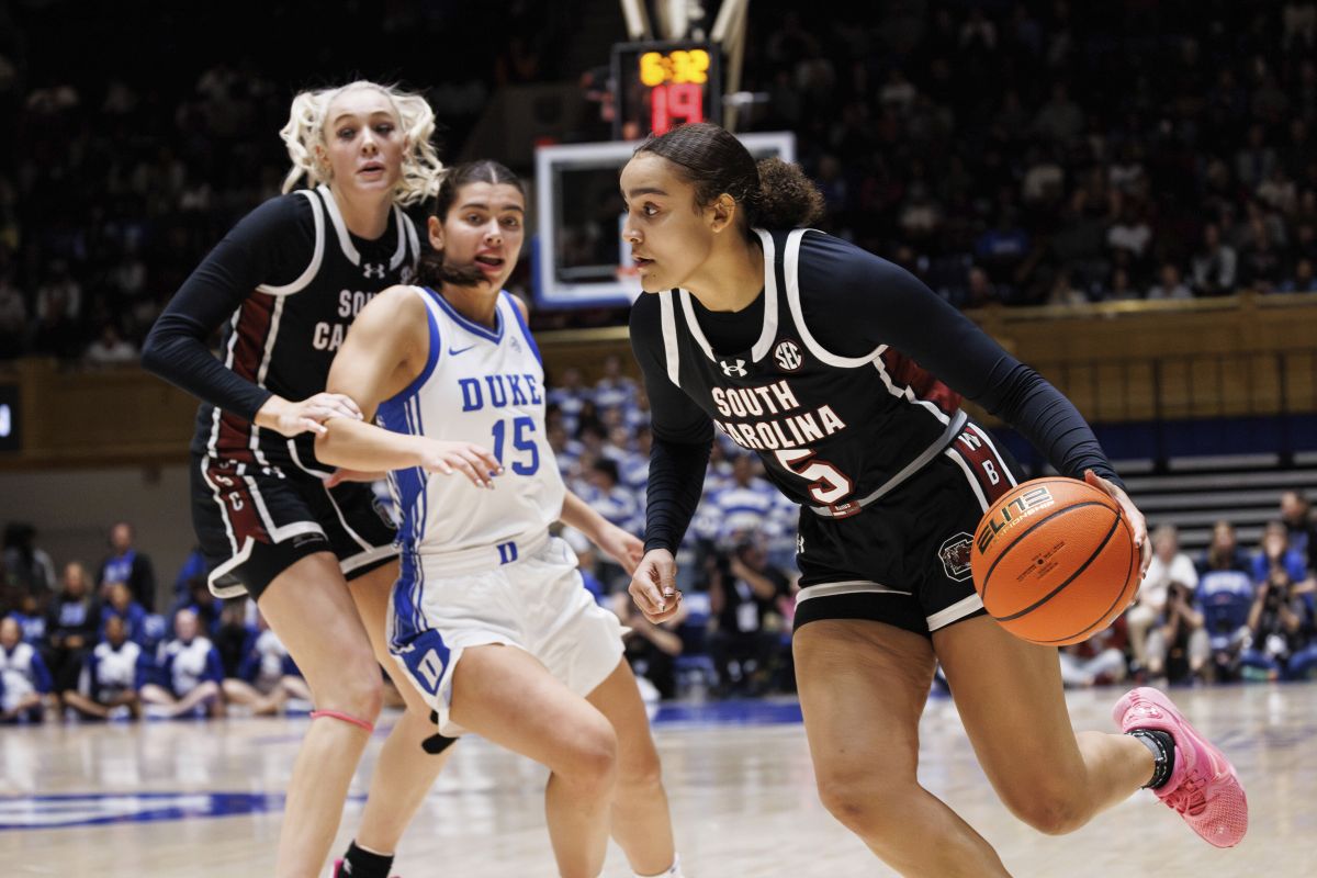 South Carolina's Tessa Johnson (5) drives past South Carolina's Chloe Kitts, left, and Duke's Emma Koabel (15) during the first half of an NCAA college basketball game in Durham, N.C., Sunday, Dec. 3, 2023.