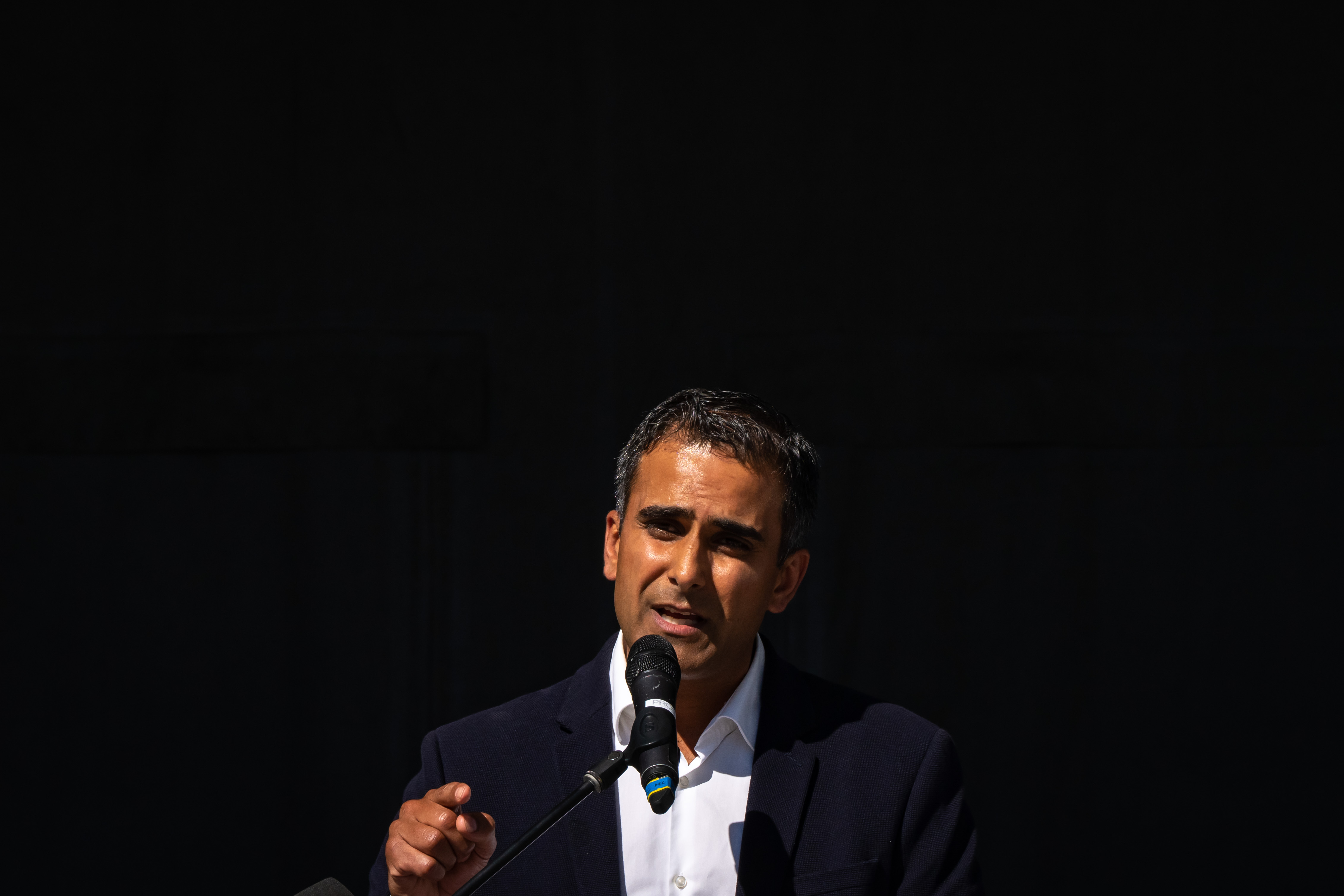 A man speaks at a microphone