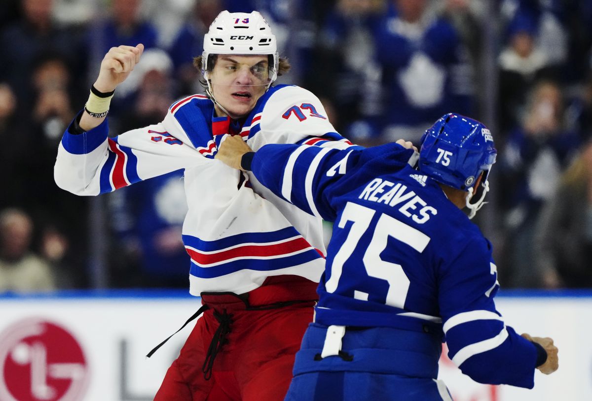New York Rangers' Matt Rempe (73) and Toronto Maple Leafs' Ryan Reaves (75) fight during third period NHL hockey action in Toronto on Saturday, March 2, 2024.