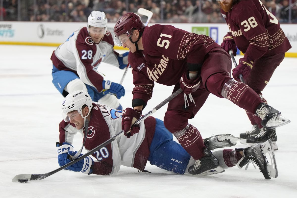 Arizona Coyotes defenceman Troy Stecher (51) takes the puck from Colorado Avalanche centre Ross Colton (20) in the first period during an NHL hockey game, Wednesday, Dec. 27, 2023, in Tempe, Ariz.