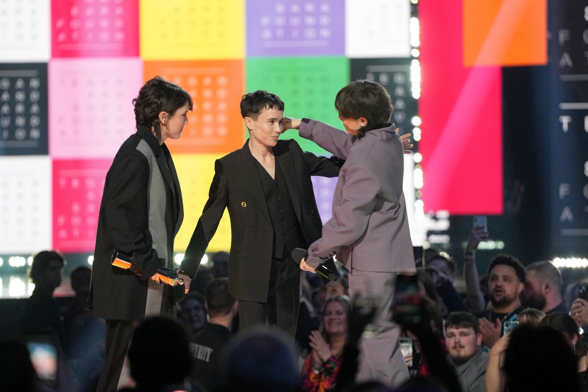 Elliot Page embraces Tegan and Sara as they accept the humanitarian award at the Juno awards, in Halifax, Sunday, March 24, 2024.