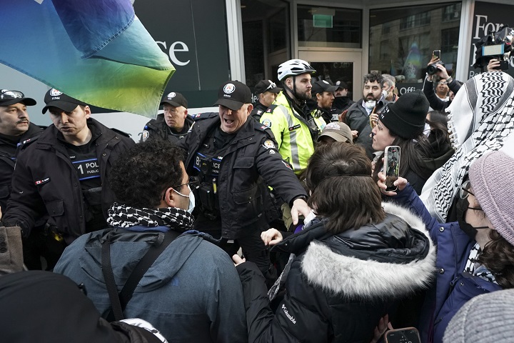 Police clash with protesters outside a fundraising event for Prime Minister Justin Trudeau, in Toronto, Friday, March 15, 2024. Rebel News personality David Menzies was among those charged on Friday as a large gathering of pro-Palestinian protesters rallied outside a downtown Toronto hotel where Trudeau was attending a Liberal party fundraiser.