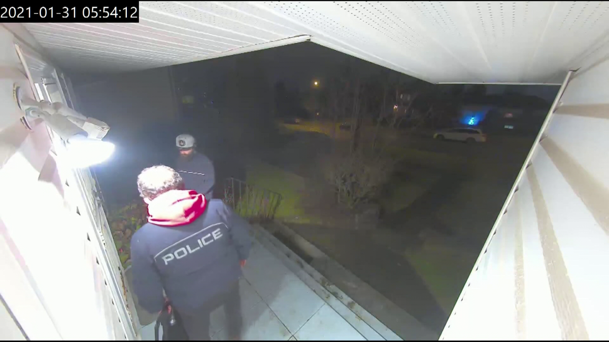 Security video shows two men wearing police jackets outside the home of Usha Singh, who was killed during a 2021 home invasion.