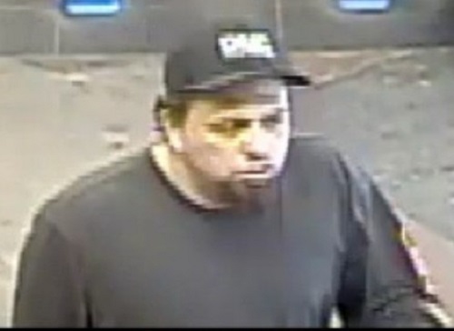 According to police, the suspect is described as male with a black goatee. He was wearing a dark baseball cap, dark grey sweater with an orange/red stripe on the left sleeve, light blue jeans, and dark brown shoes.