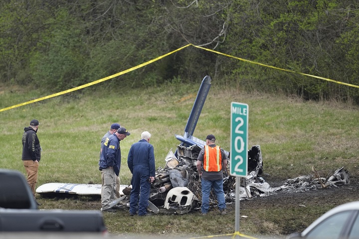Investigators look over a small plane crash alongside eastbound Interstate 40 at mile marker 202 on Tuesday, March 5, 2024, in Nashville, Tenn. 