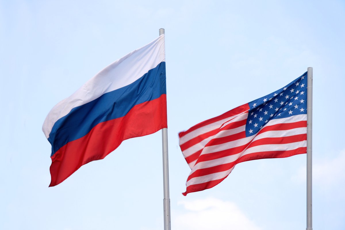 The Russian and American flags are displayed flying next to one another.