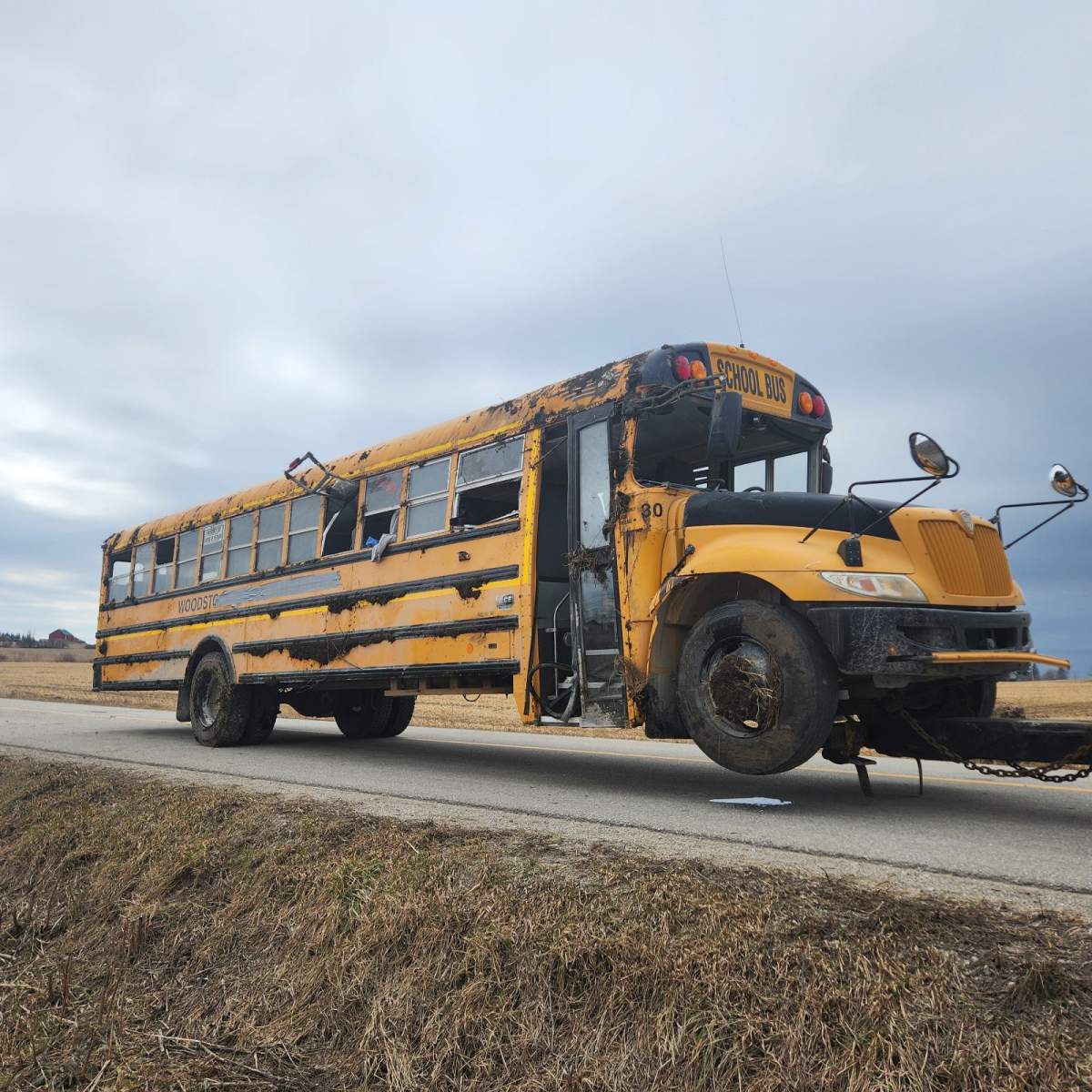 A damaged school bus being towed.