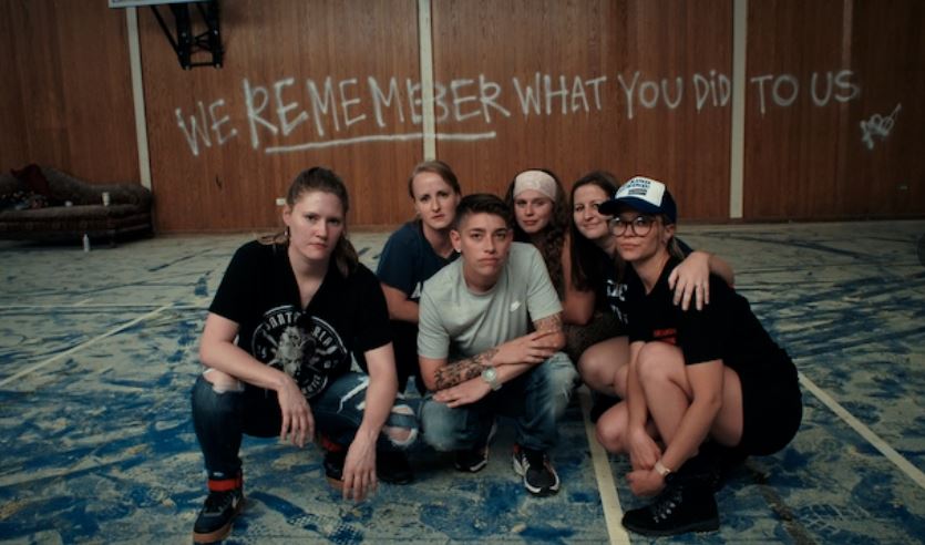 Survivors of Ivy Ridge pose for a photo inside the abandoned school.