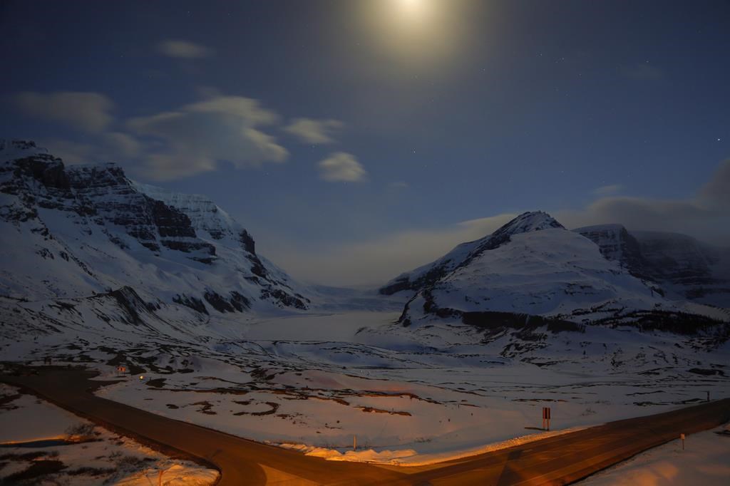 The Athabasca Glacier, centre, part of the Columbia Icefields in Jasper National Park, Alta., is seen in moonlight on May 7, 2014.