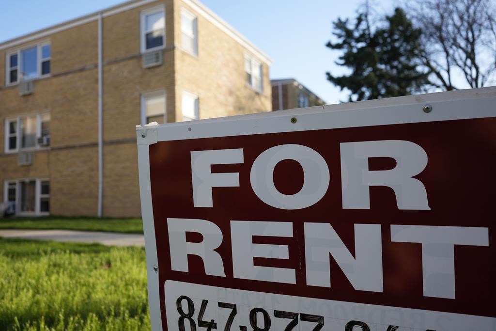 A "For Rent" sign displays outside apartment building. Rents in Hamilton, Ont are down year over year as of May 2024, according to rentals.ca (AP Photo/Nam Y. Huh).