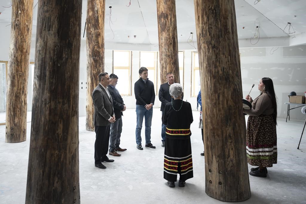 Prime Minister Justin Trudeau, third from left, takes part in a prayer and greeting ceremony before touring the long-term care facility Kiknu being built in Eskasoni First Nation on Cape Breton Island, N.S. on Thursday, Feb. 22, 2024. THE CANADIAN PRESS/Darren Calabrese.